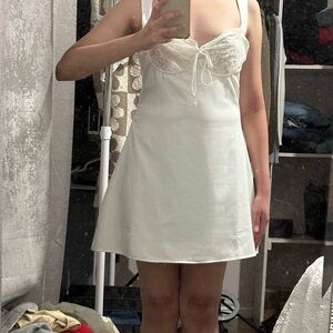 White dress with lace detailing and cute bow in front. Size:S Brand:Forever21